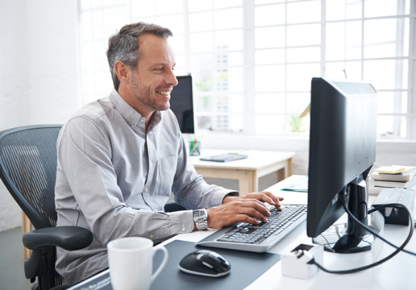 man sitting behind his computer